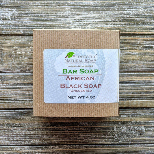 Raw African black soap close-up showing natural crumbly texture, imported unrefined bar soap 4 oz