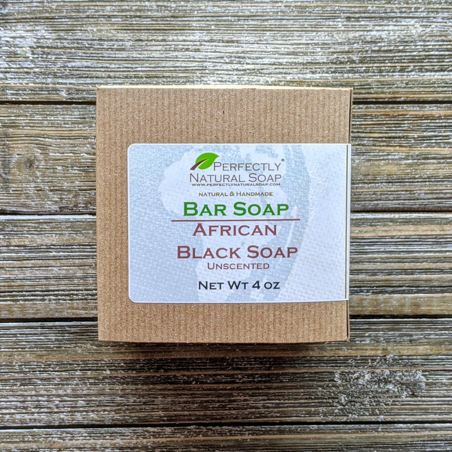 Raw African black soap close-up showing natural crumbly texture, imported unrefined bar soap 4 oz