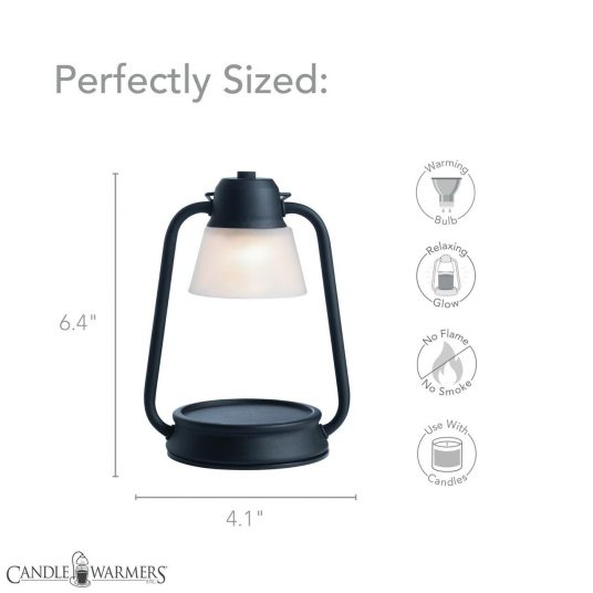 Beacon candle warmer lantern glowing with warm light through frosted shade, simple black matte design