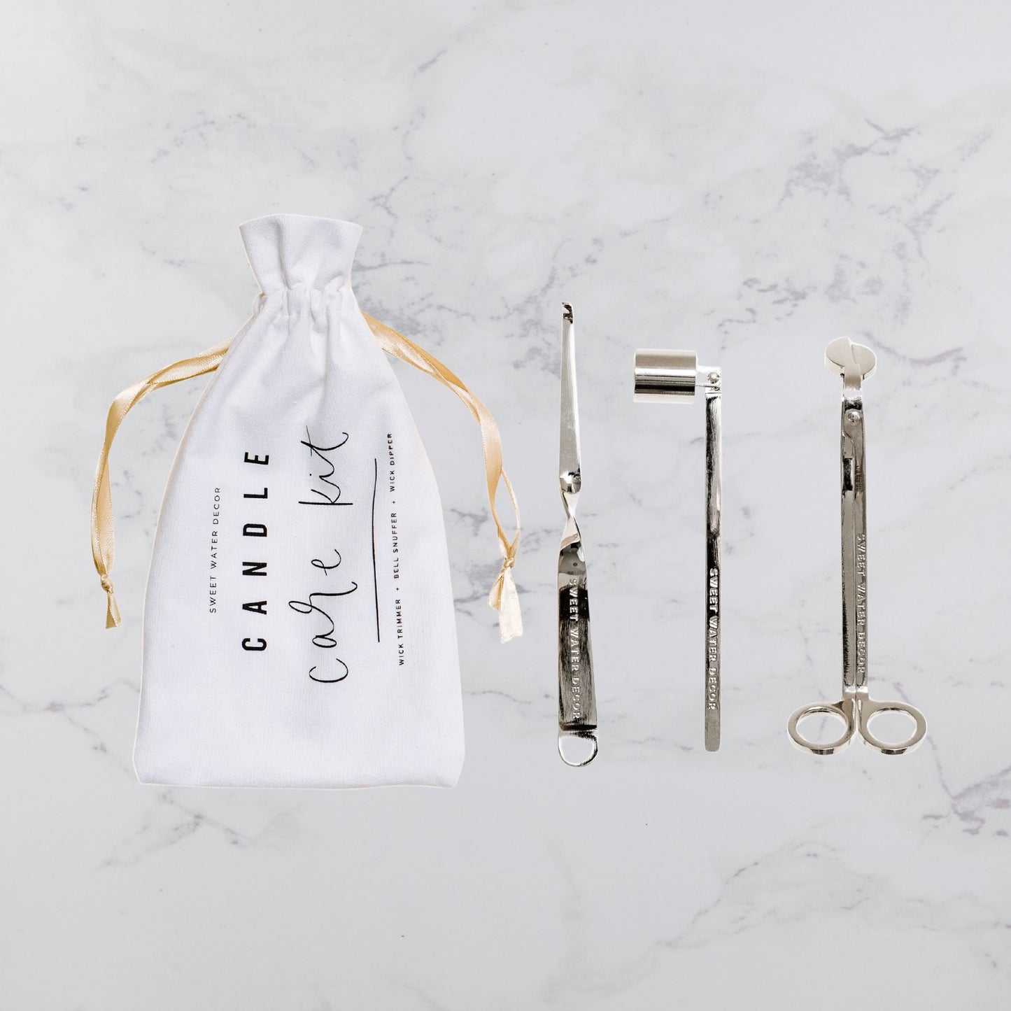 Candle care kit accessories laid out, tools for proper candle maintenance and extending candle life