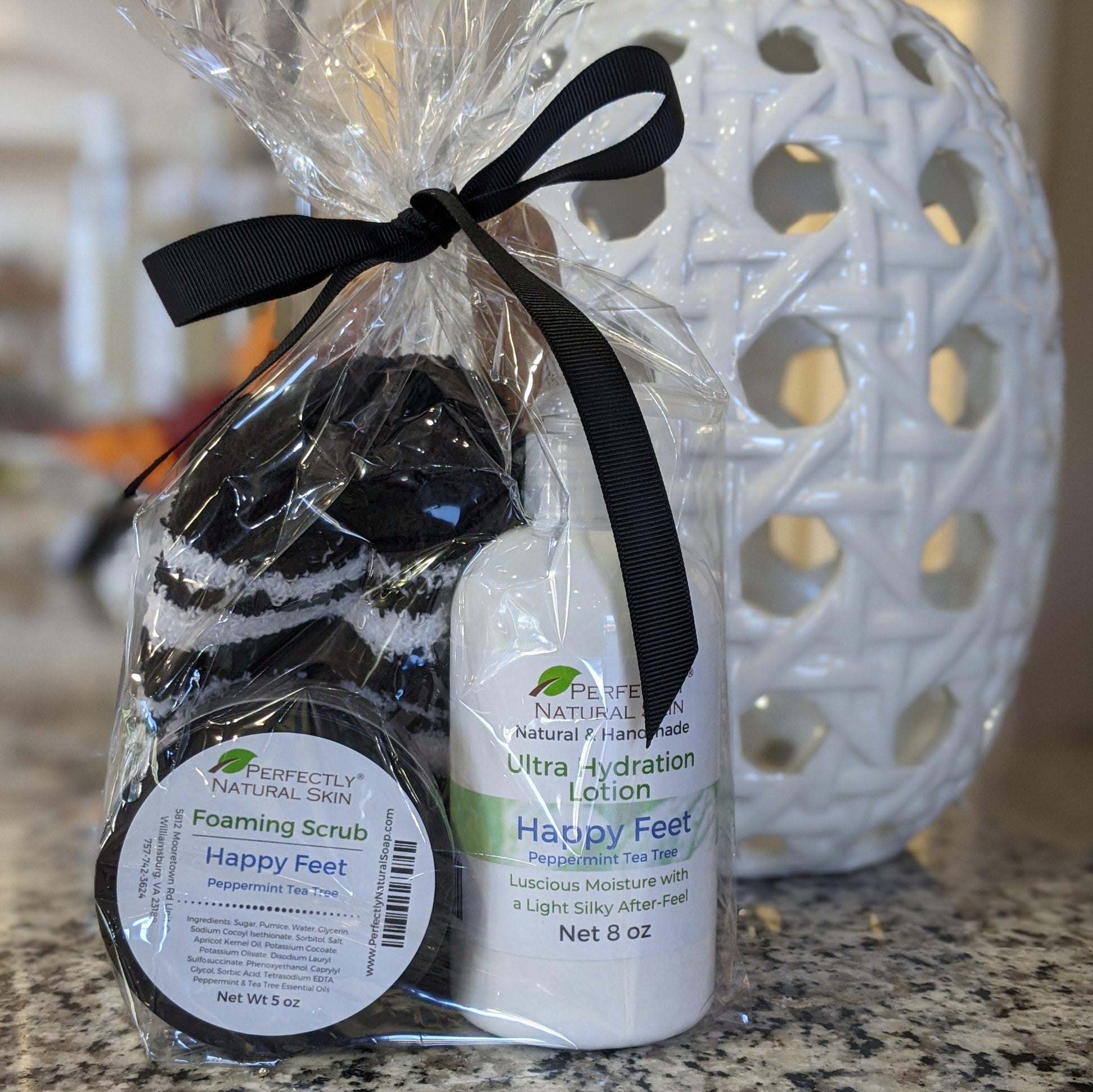 Happy Feet foot care set contents laid out showing exfoliating scrub and moisturizing foot cream
