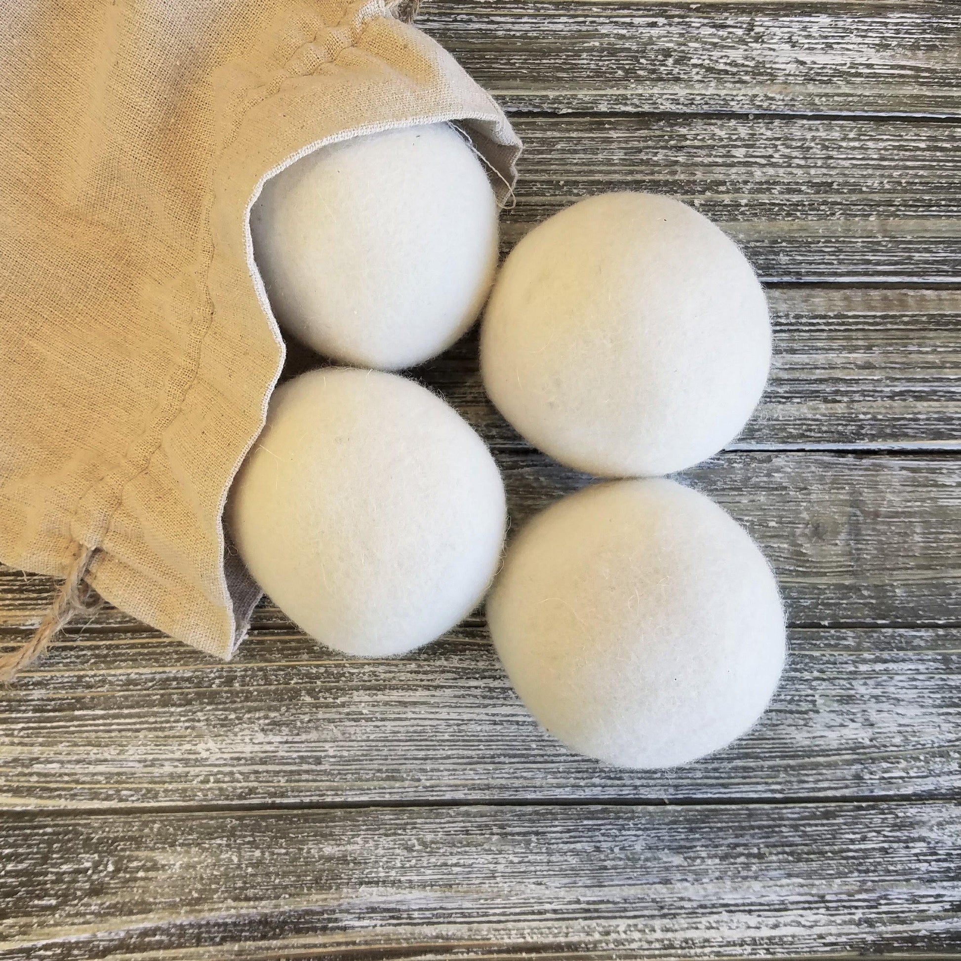 Felted wool dryer balls in use in dryer, eco-friendly reusable alternative to dryer sheets